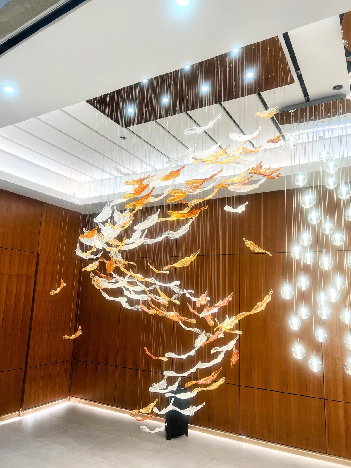 Electrician installing a light fixture in a Pelican waterfront home