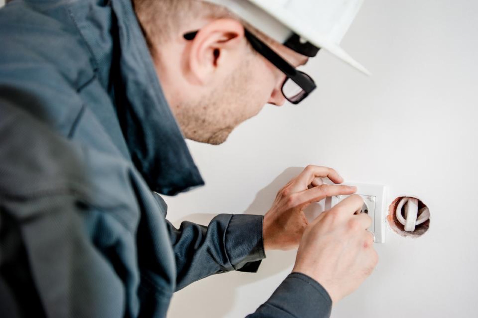 Electrician wiring an outlet during a Cape Coral electrical install